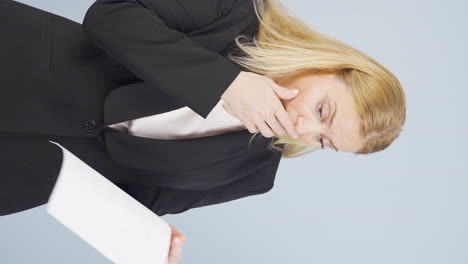 Vertical-video-of-Business-woman-examines-paperwork-and-gets-upset.